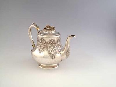 Appraisal: A Victorian baluster teapot with embossed decoration in matted reserves