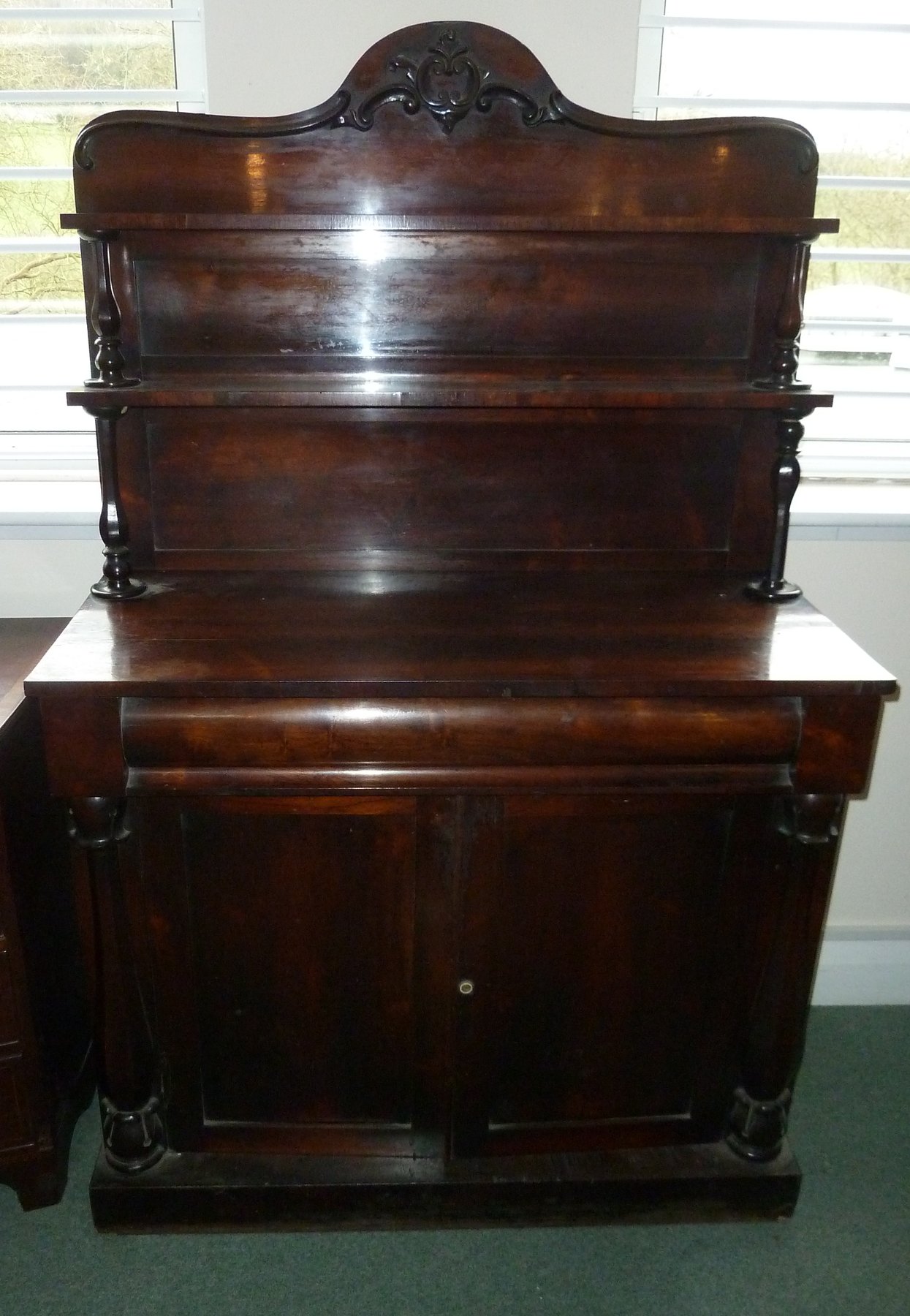 Appraisal: A Victorian mahogany chiffonier with shelves over and drawers and