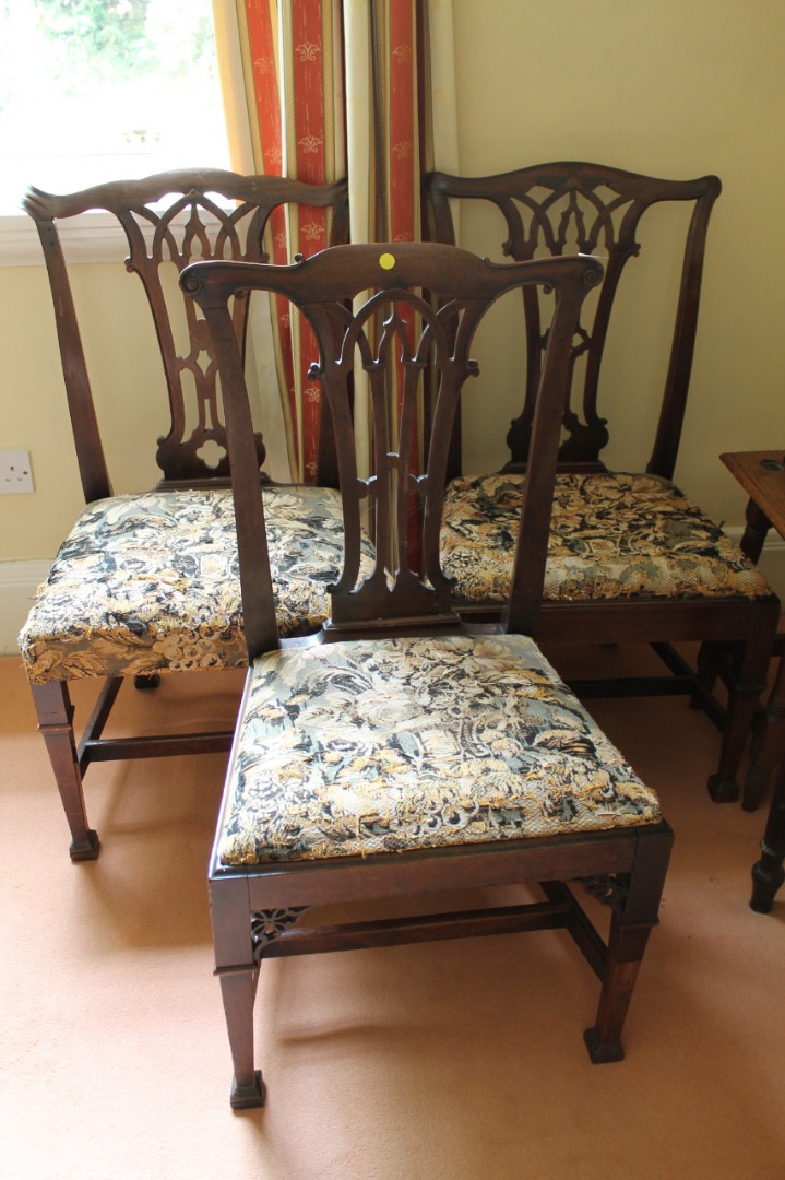 Appraisal: A harlequin group of three George III mahogany dining chairs