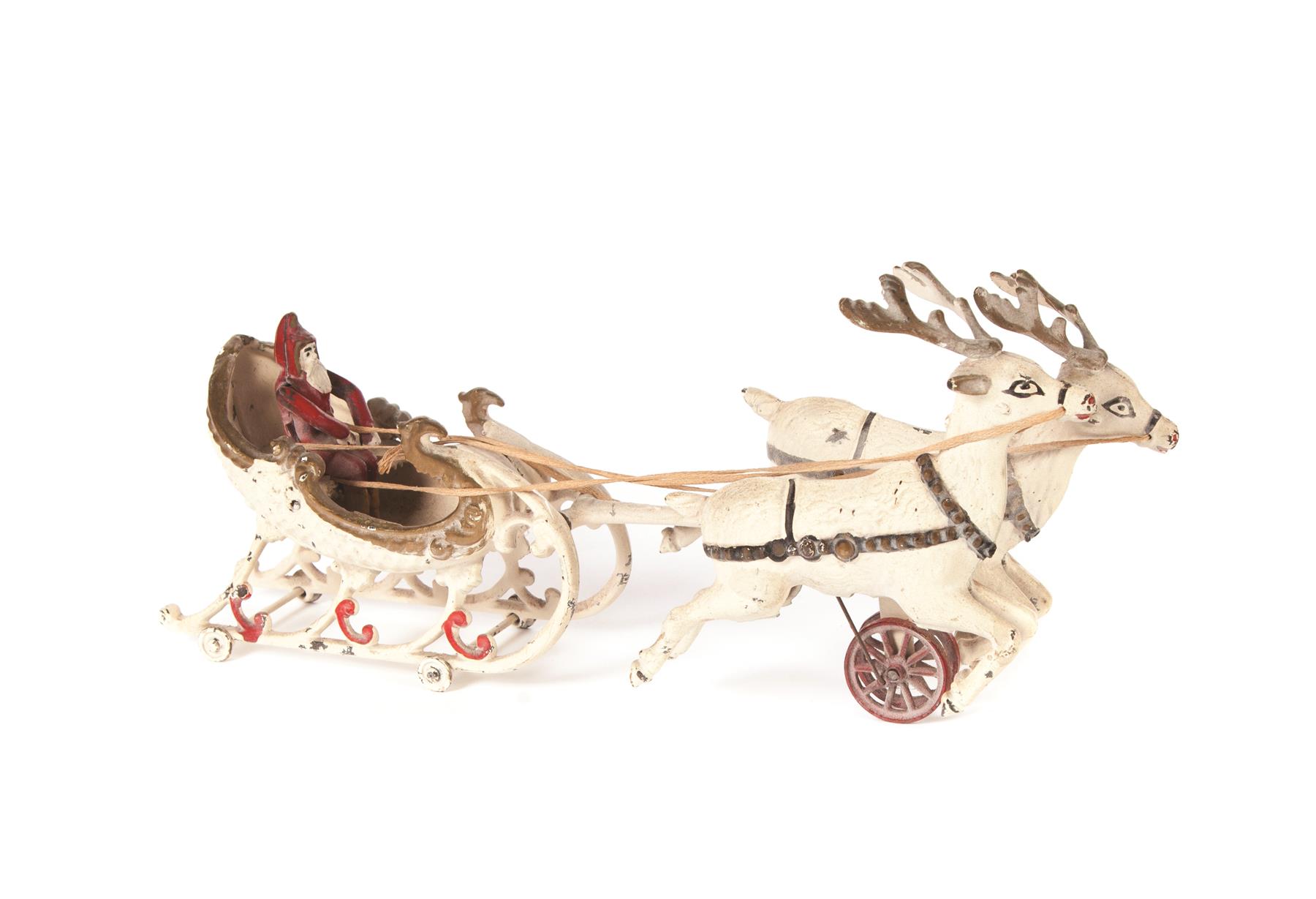 Appraisal: CAST IRON SANTA'S SLEIGH PULLED BY TWO REINDEER American ca