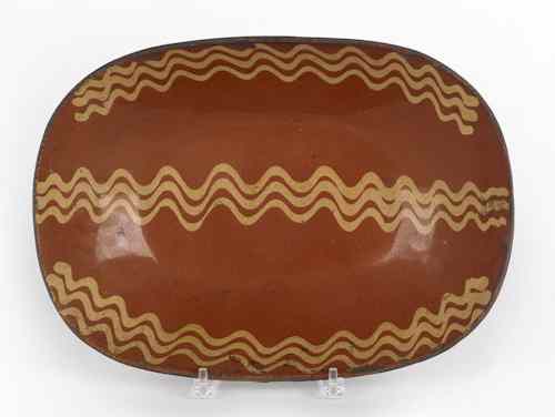 Appraisal: Pennsylvania redware loaf dish th c with yellow slip decoration