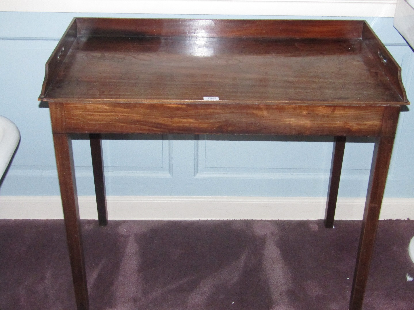 Appraisal: An mahogany washstand the three quarter gallery with pierced side