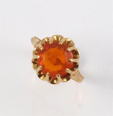 Appraisal: A fire opal ring The circular cut fire opal is