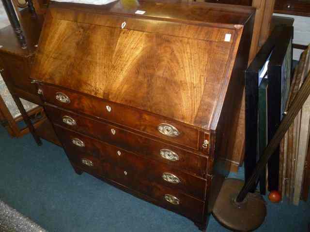 Appraisal: A GEORGE III MAHOGANY BUREAU with part fitted interior enclosed