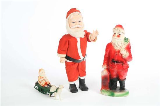 Appraisal: THREE SANTA CLAUS FIGURES A plaster standing Santa leaning on