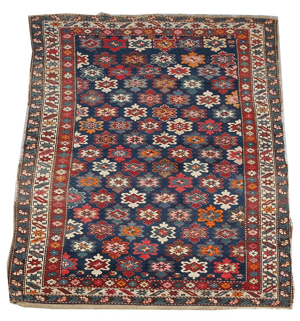 Appraisal: AN OLD SHIRVAN BLUE GROUND RUG with central polychrome flower