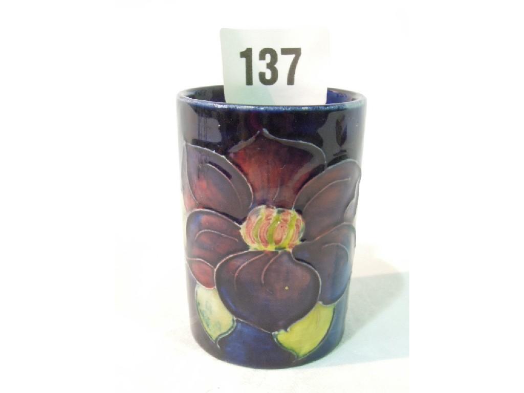 Appraisal: A small Moorcroft blue ground vase of cylindrical form with