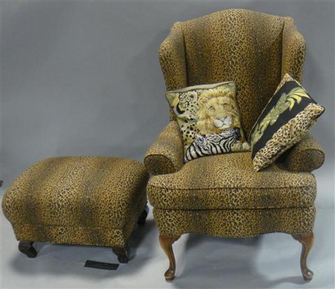 Appraisal: LEOPARD PRINT COVERED REPRODUCTION WING CHAIR AND OTTOMAN having cabriole