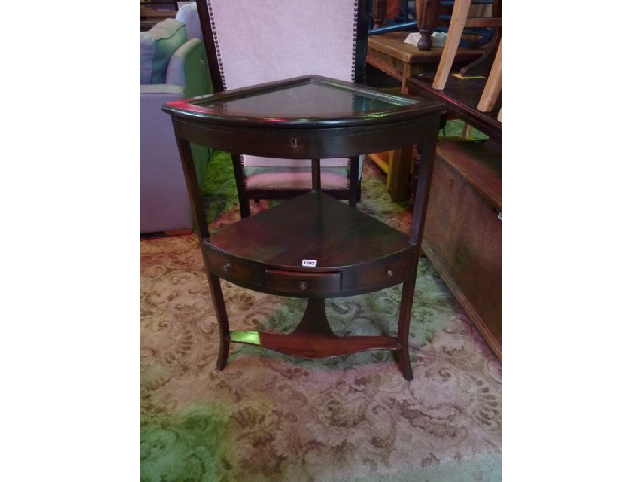 Appraisal: A small mahogany freestanding three tier corner table with shallow