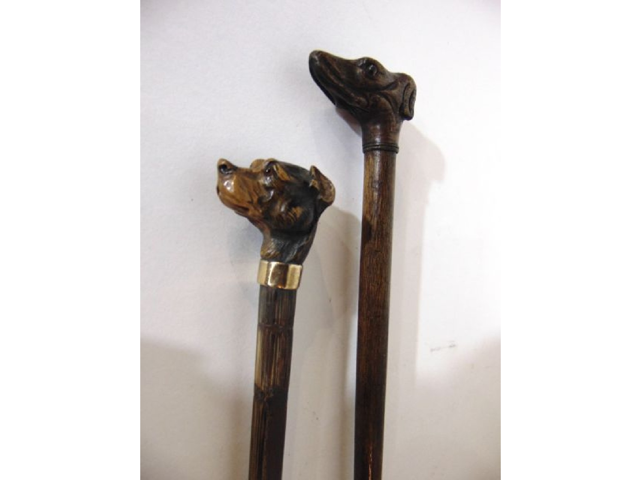 Appraisal: A slender bamboo walking cane terminating in a well carved