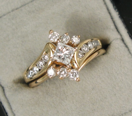 Appraisal: DIAMOND AND FOURTEEN KARAT GOLD WEDDING SET centering a princess-cut