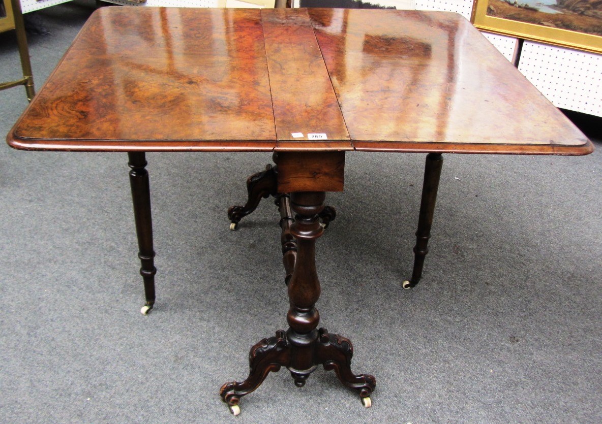 Appraisal: A Victorian figured walnut Sutherland table on baluster turned supports