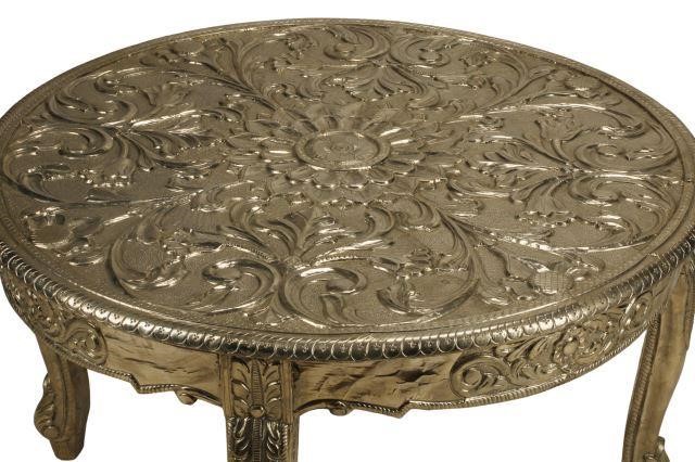 Appraisal: Silvered repousse metal-clad coffee table approx h diam