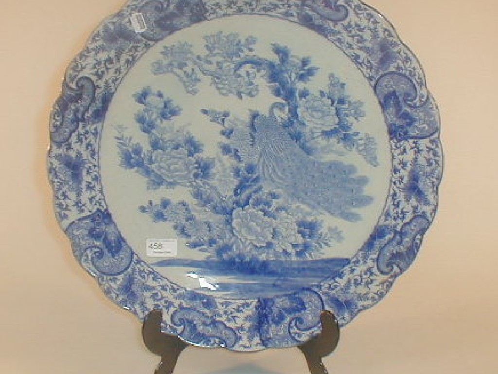 Appraisal: A Japanese blue and white charger decorated with a peacock