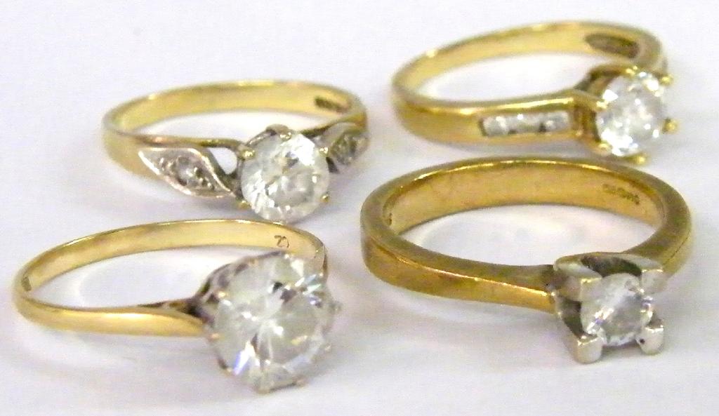 Appraisal: Four similar ct solitaire cz rings gm