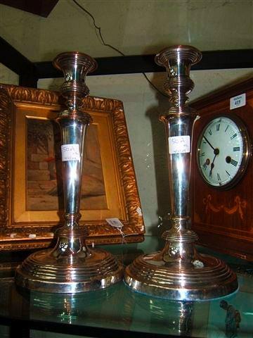 Appraisal: A pair of silver plated candle sticks high