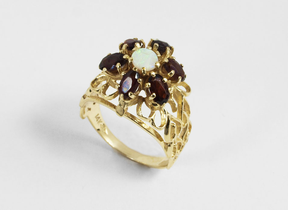 Appraisal: K OPAL AND GARNET RING K yellow gold ring contains