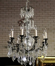 Appraisal: A cast iron and crystal eight branch chandelier th century