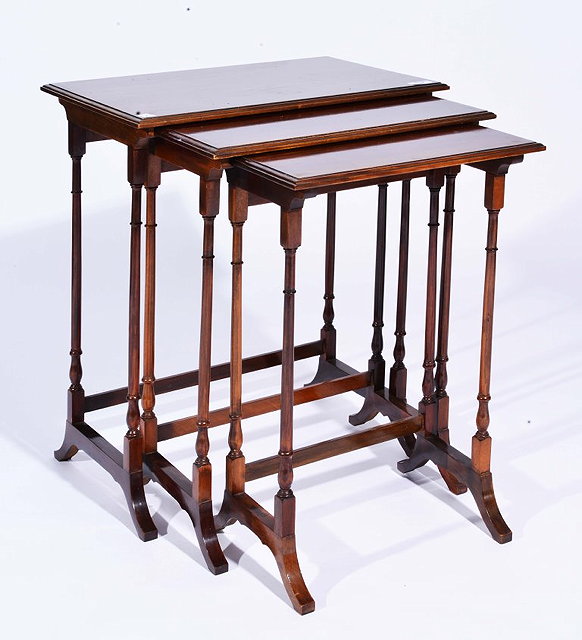 Appraisal: AN EDWARDIAN NEST OF THREE RECTANGULAR MAHOGANY OCCASIONAL TABLES largest