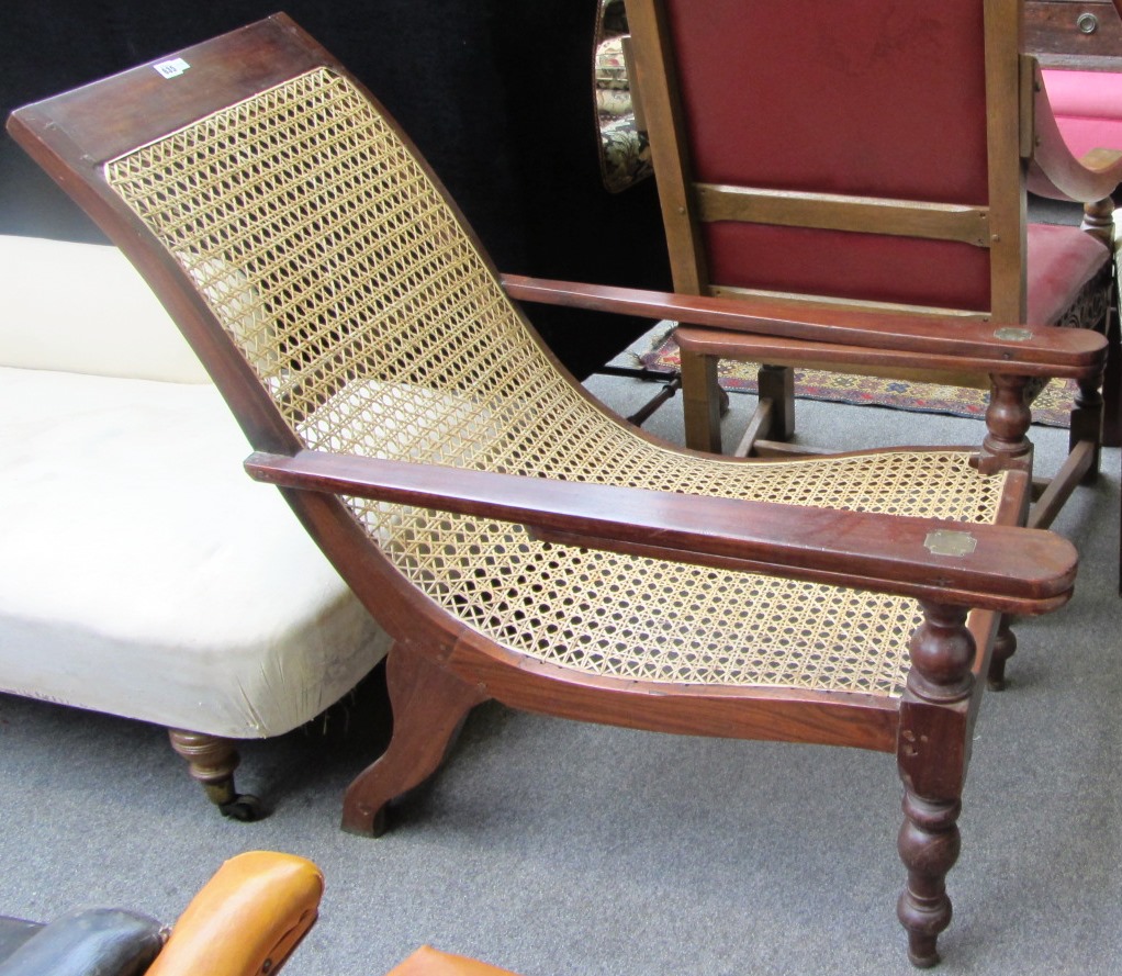 Appraisal: A hardwood framed plantation chair with cane seat and turned