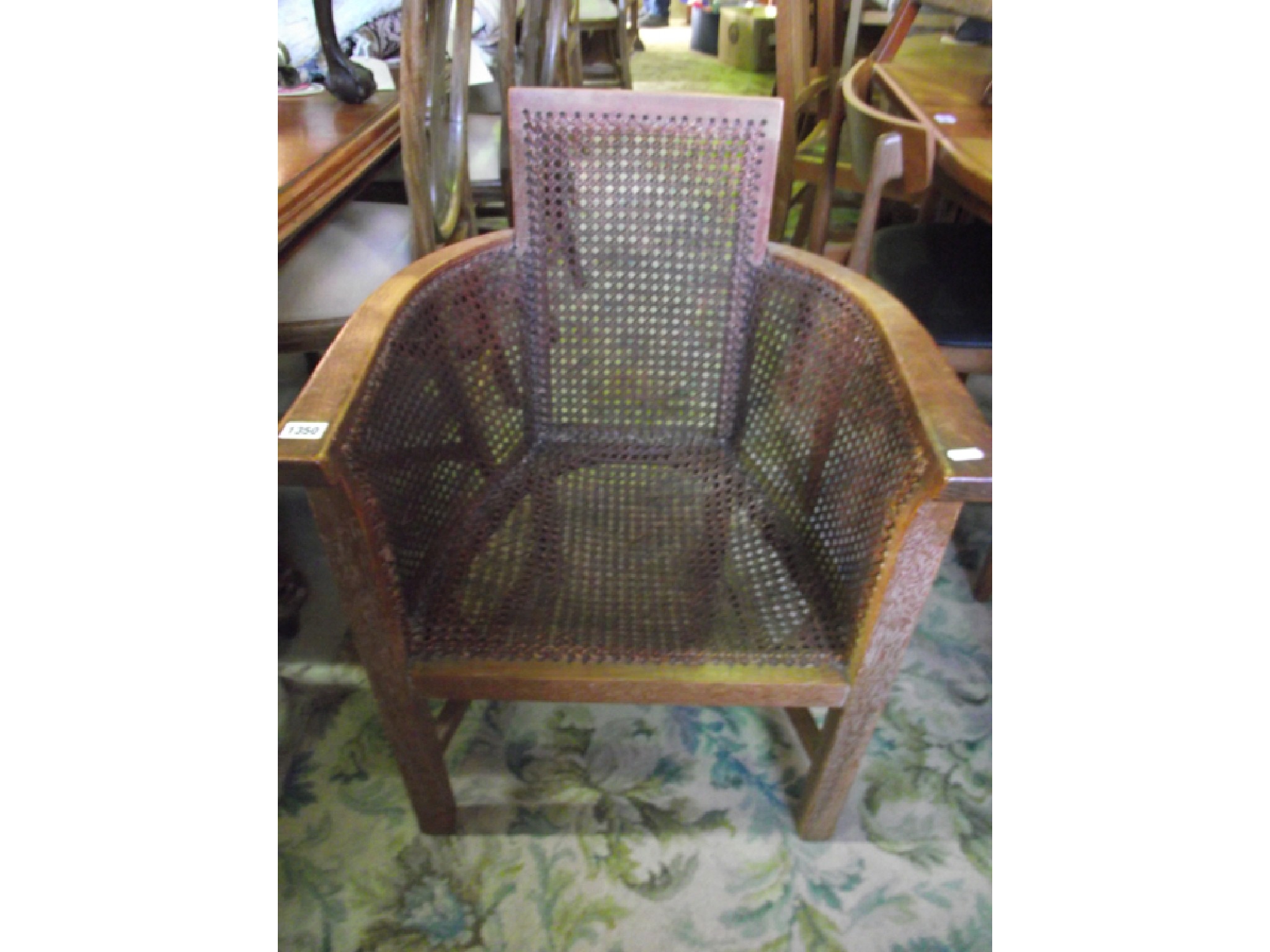 Appraisal: A s fumed oak Bergere elbow chair in the manner