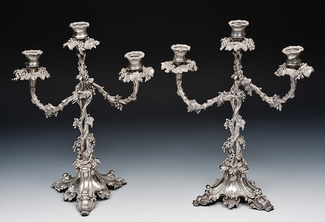 Appraisal: Pair of silver plated three branch candelabrawith allover vine leaf