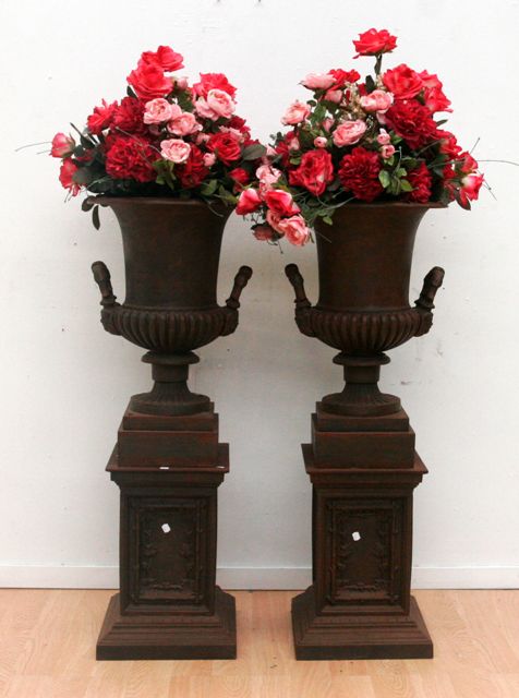 Appraisal: A pair of modern cast iron urns on stands cm