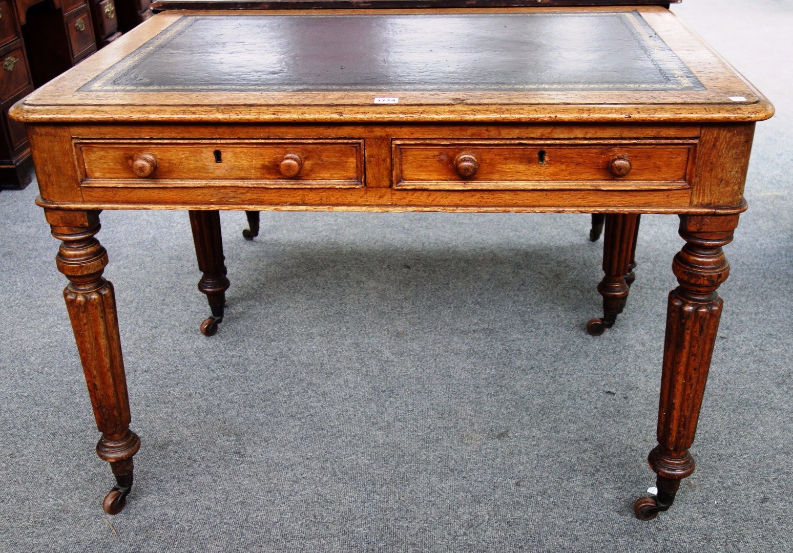 Appraisal: An early Victorian oak writing table with a pair of