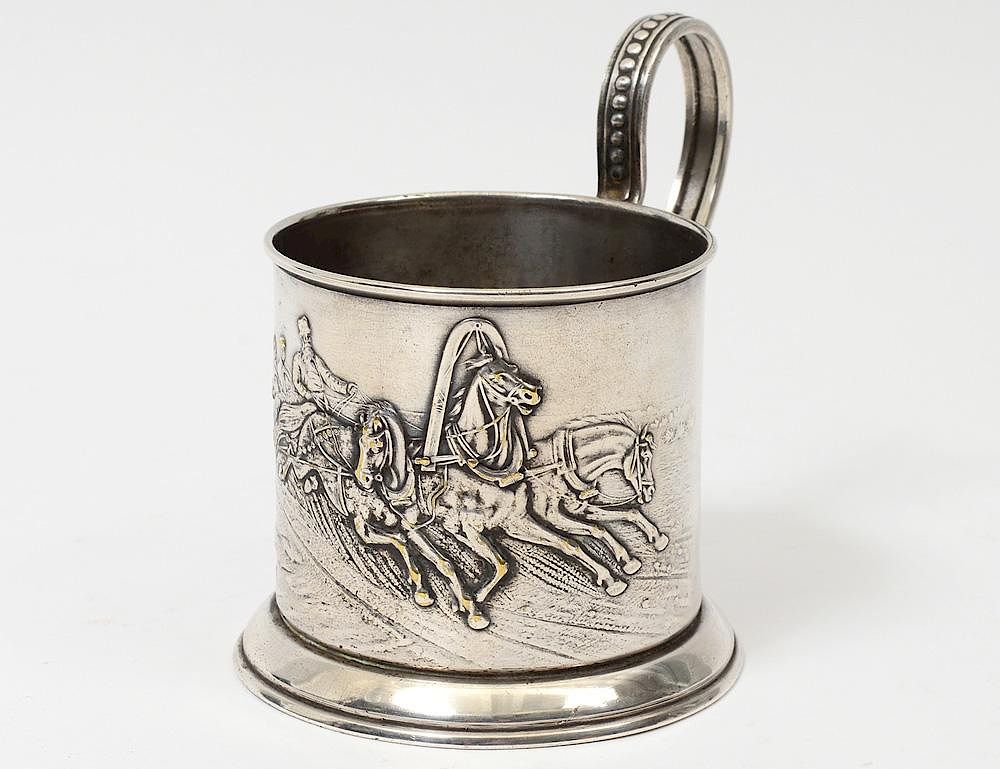 Appraisal: RUSSIAN SILVER PLATED CUP HOLDER Chased with a troika scene