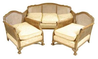 Appraisal: A walnut bergere suite the moulded leaf carved frame to