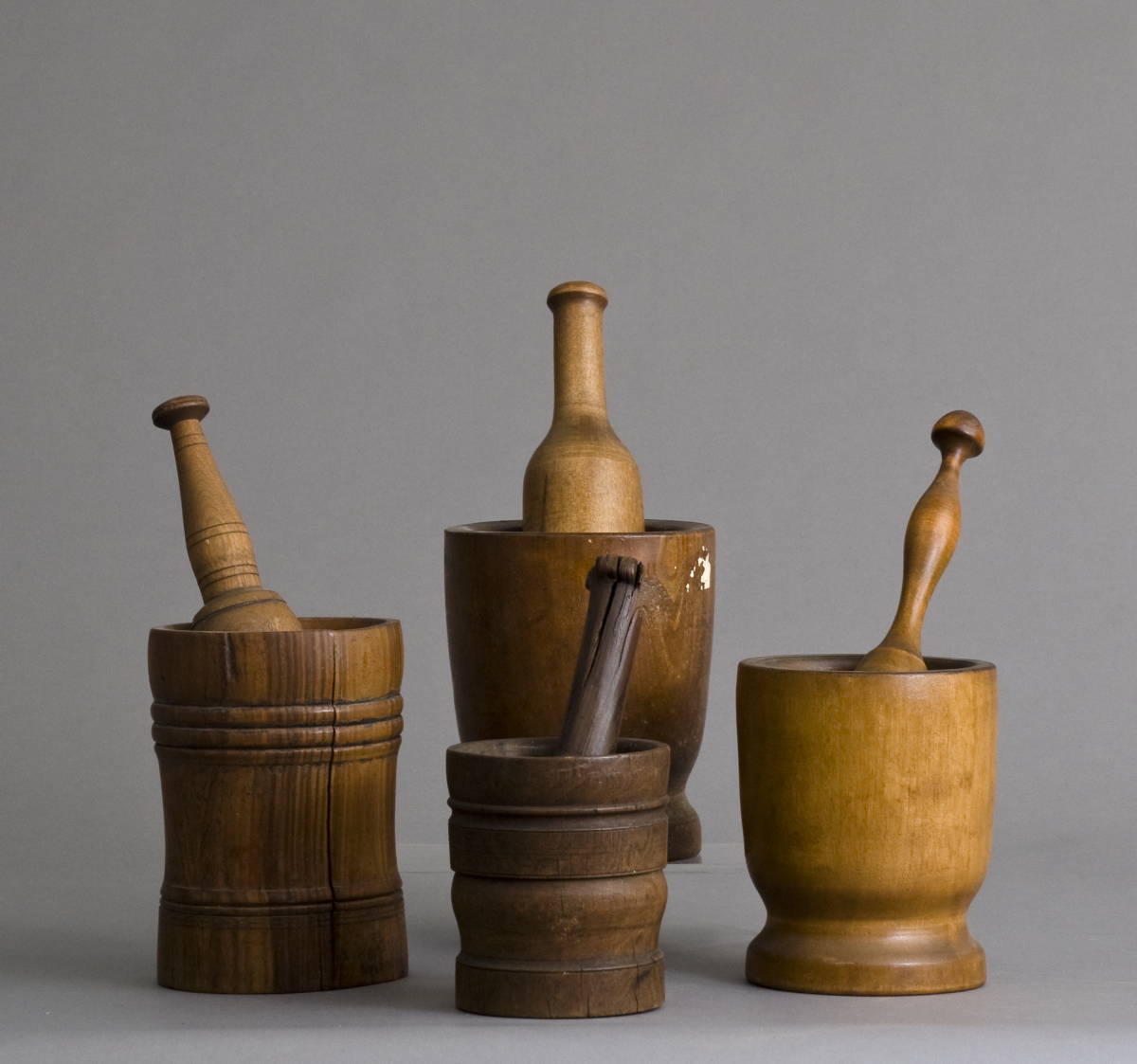 Appraisal: FOUR EARLY AMERICAN MORTARS AND PESTLES Overall height of largest