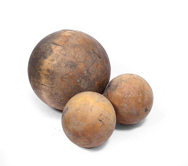 Appraisal: A LARGE TURNED PINE SPHERE cm diameter together with a