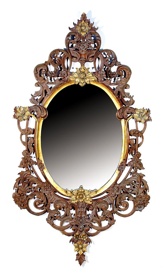 Appraisal: Rococo style carved giltwood mirror oval form with scroll-and-foliate design