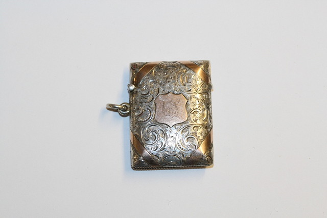 Appraisal: A VICTORIAN SILVER VESTA with engraved scroll decoration and applied