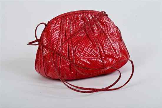 Appraisal: JUDITH LEIBER RED KARUNG HANDBAG s Fitted with three compartments