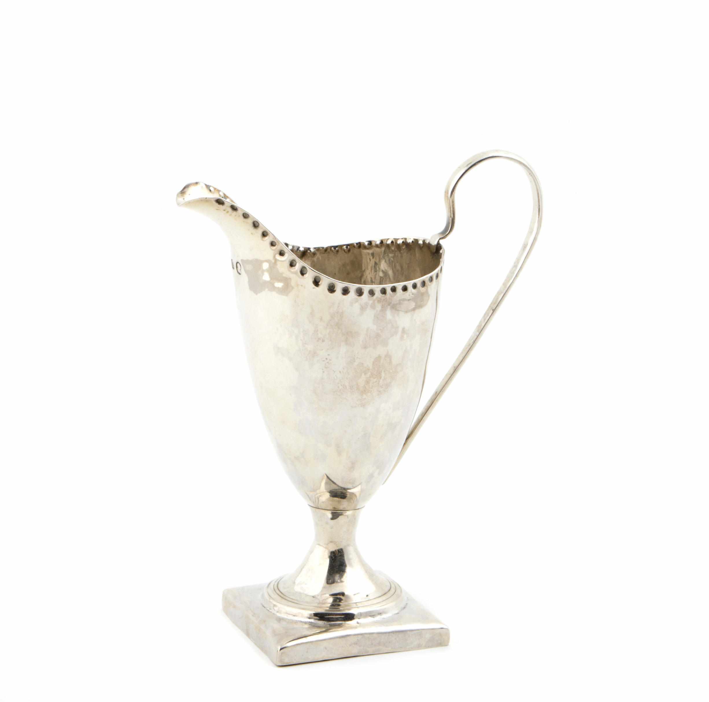 Appraisal: A George III silver cream pitcher with reverse punch beaded