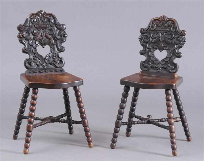 Appraisal: ASSEMBLED PAIR OF CONTINENTAL BAROQUE CARVED WALNUT CHAIRS Each shaped