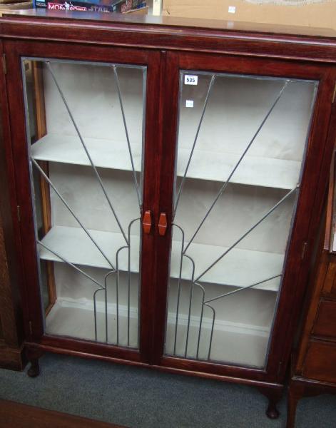 Appraisal: A th century stained oak display cabinet with a pair