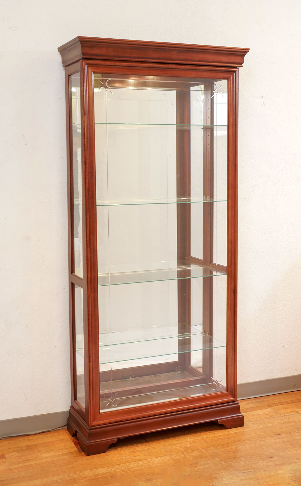 Appraisal: MODERN DISPLAY CABINET Modern glass display having a cut-glass scrolling