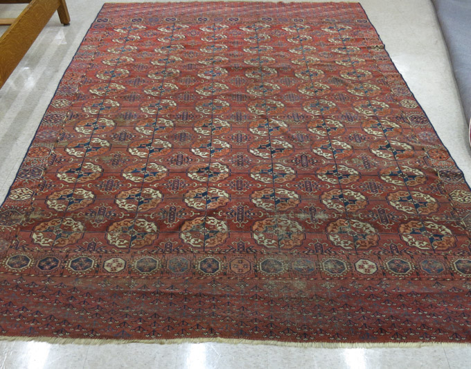 Appraisal: ANTIQUE TURKOMAN BOKHARA CARPET featuring six columns of geometric Turkoman