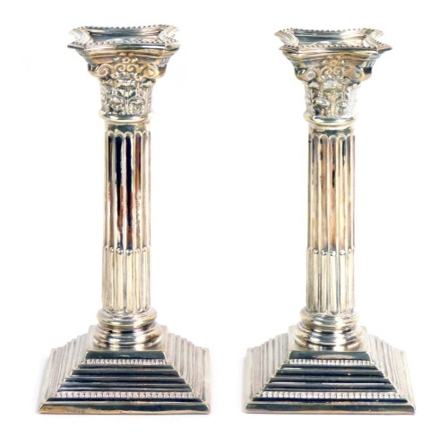 Appraisal: A pair of silver taper candlesticks each on Corinthian column