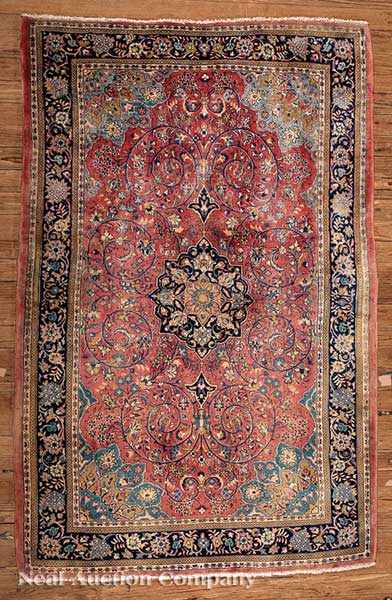 Appraisal: A Persian Kashan Carpet rose ground with navy accented central