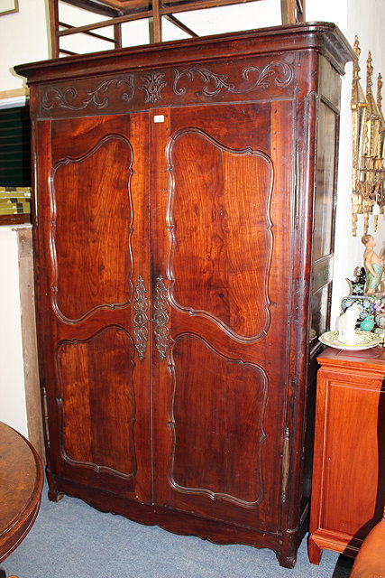 Appraisal: AN TH CENTURY FRENCH CHERRY ARMOIRE the carved acanthus moulding