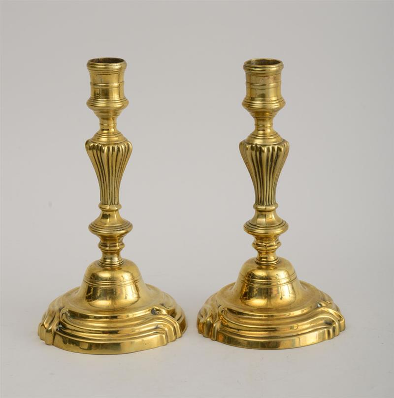 Appraisal: PAIR OF LOUIS XV BRASS CANDLESTICKS Each reeded baluster-form stem