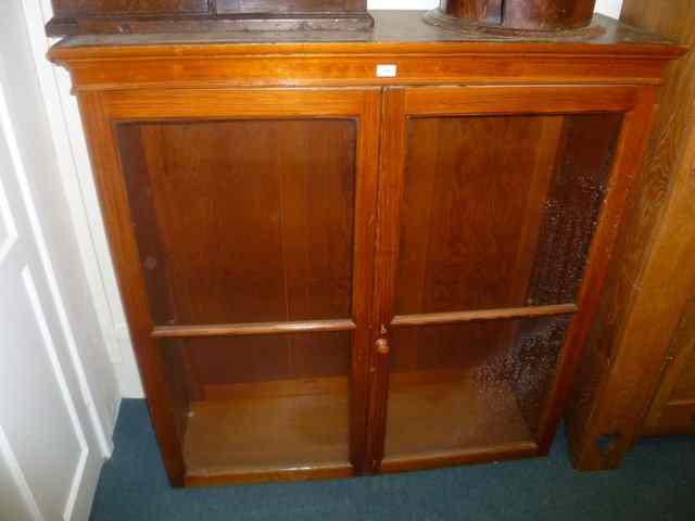 Appraisal: A VICTORIAN PITCH PINE DISPLAY CABINET enclosed by two glaze