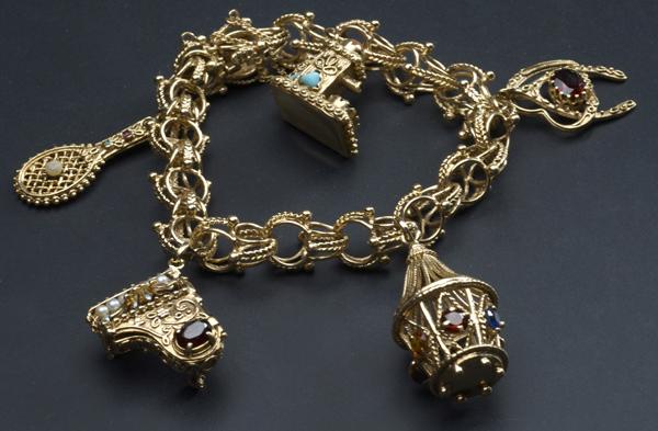 Appraisal: GOLD CHARM BRACELET k yg with five gem-set figural charms