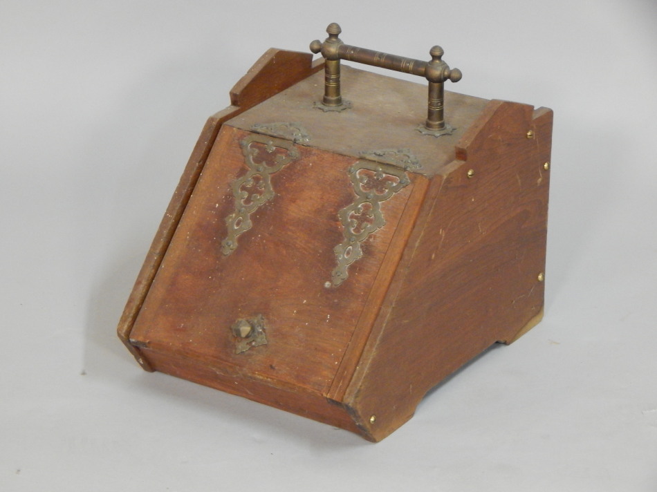 Appraisal: A Victorian walnut and brass mounted coal scuttle with a