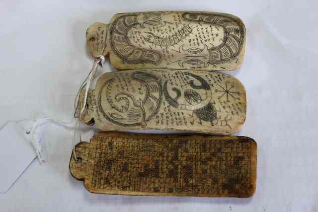 Appraisal: THREE RIB BONE AMULETS with scratch carved decoration to the