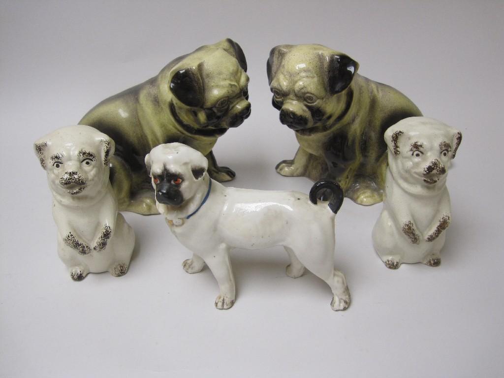 Appraisal: Pair of seated Pug Dogs with yellow black glazes in