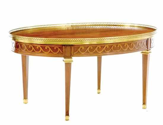 Appraisal: Baker mahogany and rosewood coffeetable oval top with pierced brass